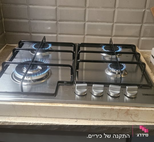 כיריים גז עם ארבעה מבערים דולקים